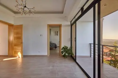 a hallway of a house with a chandelier at Villa Favella-Pop-Art-View-7BR-Jamaca De Dios-Balcony-Dream in Jarabacoa