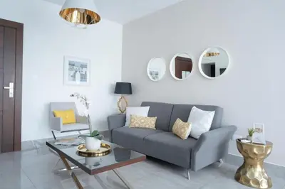 a living room with a couch and a table at Soha suites I in Santiago de los Caballeros