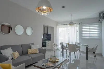 a living room with a couch and a table at Soha suites I in Santiago de los Caballeros