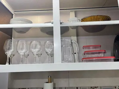 a row of wine glasses sitting on a shelf at Hospedaje de marant 1 in San Felipe de Puerto Plata