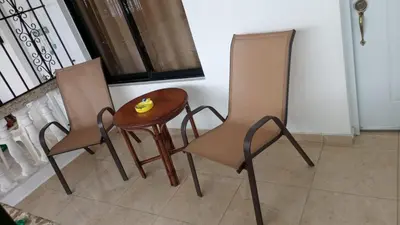 two chairs and a table with a banana on it at Hospedaje de marant 1 in San Felipe de Puerto Plata