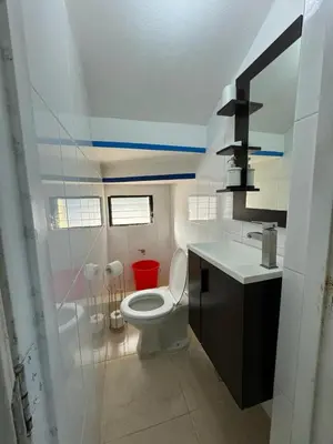 a bathroom with a toilet and a sink at El más completo, a menos de 5 minutos de la playa, free wifi fuera del alojamiento in San Felipe de Puerto Plata