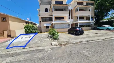 a car parked in a parking lot in front of a building at El más completo, a menos de 5 minutos de la playa, free wifi fuera del alojamiento in San Felipe de Puerto Plata