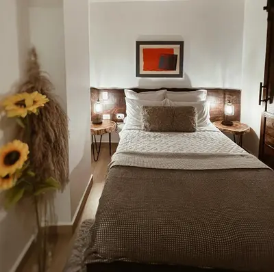 a bedroom with a bed and a vase of flowers at Studio 27 in Santo Domingo