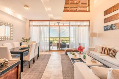 a living room with a couch and a table at Golf View Apt at Casa De Campo in El Infiernito