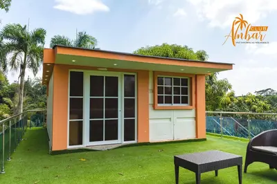 a small house with a green lawn at Villas Club Ámbar in Cacique