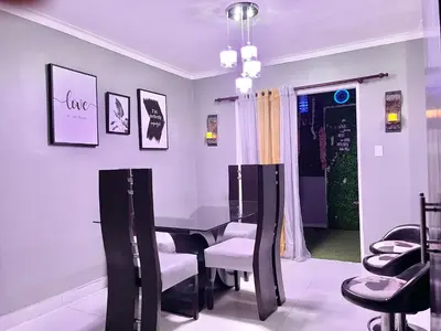 a dining room with a table and chairs at Residencial PALMA REAL in Santiago de los Caballeros