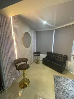 a living room with a black couch and a mirror at Mar azul puerto plata in San Felipe de Puerto Plata