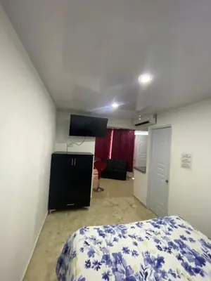 a bedroom with a bed and a flat screen tv at Mar azul puerto plata in San Felipe de Puerto Plata