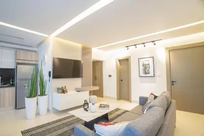 a large living room with a couch and a kitchen at SOHA PANORAMA in Santiago de los Caballeros
