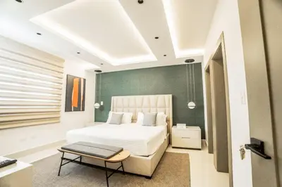 a bedroom with a bed and a table in it at SOHA PANORAMA in Santiago de los Caballeros
