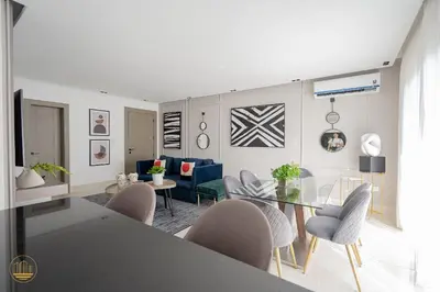 a dining room and living room with a dining table and chairs at SOHA PANORAMA in Santiago de los Caballeros