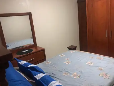 a bedroom with a bed with a dresser and a mirror at Apartamentos Kika in San Felipe de Puerto Plata