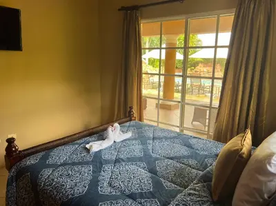 a stuffed animal is laying on a bed at Charming 3 bedroom villa 66 with private pool in Sosúa