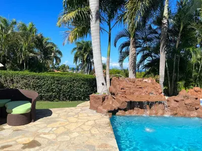 a swimming pool with a rock fountain in a resort at Charming 3 bedroom villa 66 with private pool in Sosúa
