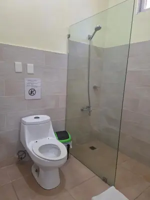 a bathroom with a toilet and a shower at Hotel Enrique I Gazcue, Bed and Breakfast in Santo Domingo