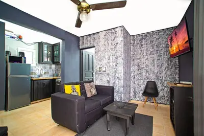a living room with a couch and a kitchen at One Bedroom Apartment in Sosua , Great for Remote Workers Fast Wifi in Sosúa
