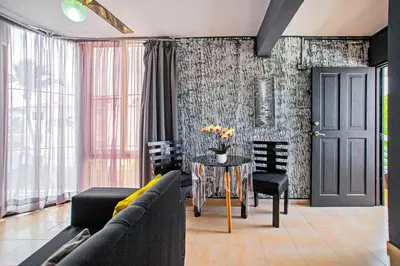 a living room with a couch and a table with chairs at One Bedroom Apartment in Sosua , Great for Remote Workers Fast Wifi in Sosúa