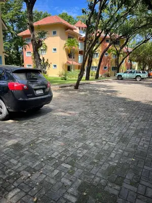 a car parked in a parking lot in front of a building at Hermoso apartamento de playa en perla marina Sosua - Cabarete in Sosúa