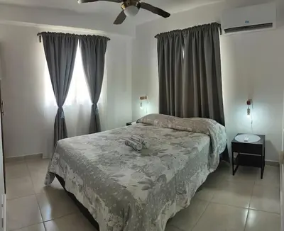 a bedroom with two beds and a ceiling fan at Minerva in La Ureña