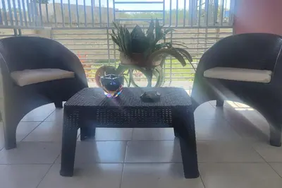 a table with a vase on it next to two chairs at Minerva in La Ureña