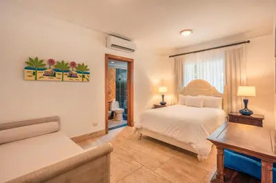 a bedroom with a bed and a couch at Glamorous w Jacuzzi Balcones del Atlntico in Portillo