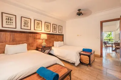 a bedroom with two beds and a table at Glamorous w Jacuzzi Balcones del Atlntico in Portillo