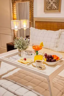 a white coffee table with a tray of fruit on it at Naranjo Hotel Boutique in Higuey