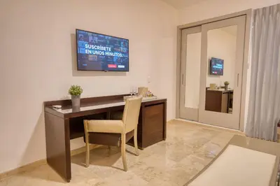 a office with a desk with a chair and a scoreboard at Naranjo Hotel Boutique in Higuey