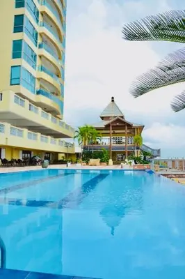 a large blue swimming pool next to a tall building at Exclusive 3 BDR, Gym & Pool, SeaView, Luxury Tower in Santo Domingo