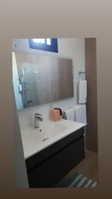 a bathroom with a sink and a mirror at Torre Rialto in Santiago de los Caballeros