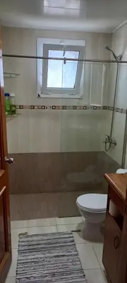 a bathroom with a shower and a toilet and a window at Room beach-front with private bathroom -Adults only in Punta Cana