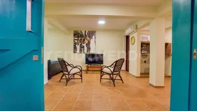 a living room with chairs and a tv at El Yaguacil villa in Jarabacoa