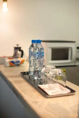 two bottles of water on a tray on a kitchen counter at PH 19 Guesthouse Hotel in Gazcue in Santo Domingo
