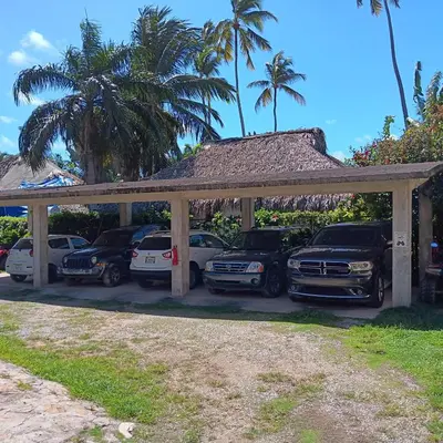 a car garage with cars parked in it at La Cortesana Cozy Apt Steps to the Beach in Las Terrenas