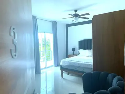 a bedroom with a bed and a ceiling fan at Gaia Residence Deluxe in San Felipe de Puerto Plata