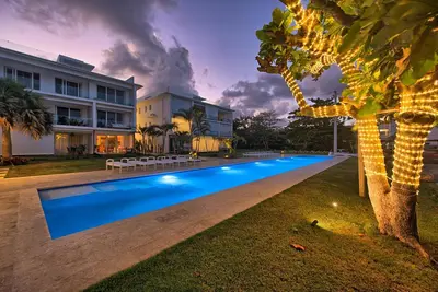 a swimming pool in front of a house at Amazing ocean view apartment with grand pool in Cabarete