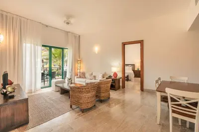 a living room with a couch and a table at Go away to this charming apt at Sublime w private jacuzzi included in Las Terrenas