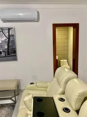 a living room with a couch and a chair at Spectacular PentHouse with private jacuzzi terrace in Santiago de los Caballeros