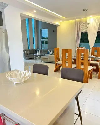 a kitchen and living room with a table and chairs at 5 Star Villa minutes from Airport and Beaches in Sosúa