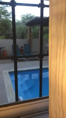 a view of a swimming pool through a window at Apartamento CGM de 1 habitación in La Romana