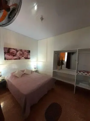 a bedroom with a large bed and a mirror at Apartamento Hogareño in Jarabacoa