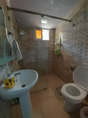 a bathroom with a white sink and a toilet at Apartamento Hogareño in Jarabacoa