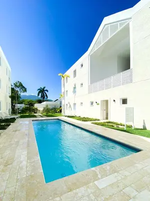 a swimming pool in front of a building at Xeliter Green One Playa Dorada in San Felipe de Puerto Plata