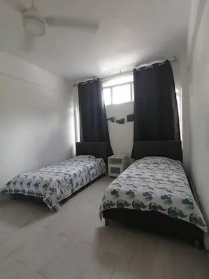 a bedroom with two beds and a window at Indy's Best Bay FrontView in Samana. in Santa Bárbara de Samaná