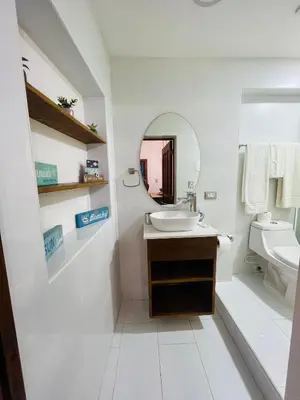 a white bathroom with a sink and a mirror at Lovely Beachfront 2 bedrooms condo with 2 pools in Las Terrenas