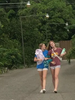 two women walking down a road with a baby at Complejo Ecoturistico Rancho Cielo in Licey al Medio