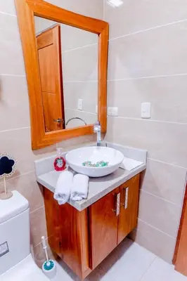 a bathroom with a sink and a mirror at Modern apartment in Santiago de Los caballeros in Santiago de los Caballeros
