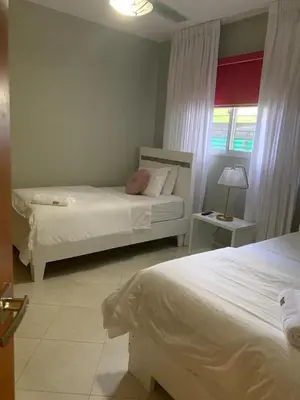 a bedroom with two beds and a window at Modern apartment in Santiago de Los caballeros in Santiago de los Caballeros