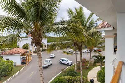 a view of a street with palm trees and cars at Hotel Palmera Bayahibe in Bayahibe